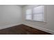 Cozy bedroom with hardwood floors, white trim, and natural light from the window at 1006 Byron Sw Dr, Atlanta, GA 30310