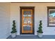 Stylish front door with decorative glass flanked by spiral topiaries, enhancing curb appeal at 1006 Byron Sw Dr, Atlanta, GA 30310