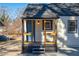 Home exterior featuring a blue front door, wood porch columns and tidy landscaping at 1006 Byron Sw Dr, Atlanta, GA 30310