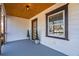 Cozy front porch with stained wood ceiling, wood railing, and lush potted spiral topiaries at 1006 Byron Sw Dr, Atlanta, GA 30310