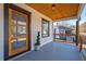 Inviting front porch featuring a stylish front door, wood ceiling, and a charming view of the neighborhood at 1006 Byron Sw Dr, Atlanta, GA 30310