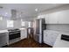 Open concept kitchen with stainless appliances, white cabinets, and marble countertops at 1006 Byron Sw Dr, Atlanta, GA 30310