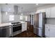 Open concept kitchen with stainless appliances, white cabinets, and marble countertops at 1006 Byron Sw Dr, Atlanta, GA 30310