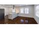 Bright kitchen with marble island, stainless hood, recessed lights, and dark wood flooring at 1006 Byron Sw Dr, Atlanta, GA 30310