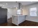 Bright kitchen with marble island, stainless hood, recessed lights, and dark wood flooring at 1006 Byron Sw Dr, Atlanta, GA 30310