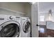 Bright laundry room with washer, dryer, and shelving, conveniently located near the kitchen at 1006 Byron Sw Dr, Atlanta, GA 30310