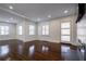 Open living area featuring hardwood floors, a fireplace, and a large window at 1006 Byron Sw Dr, Atlanta, GA 30310