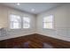 Sunlit living room boasts wainscoting detail, hardwood floors, and bright windows at 1006 Byron Sw Dr, Atlanta, GA 30310