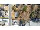 Aerial view of a compact home nestled among mature trees with street access and ample parking at 122 Goldie Se Dr, Marietta, GA 30067