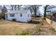 View of home's siding and backyard with some bare areas, and wooden fence for privacy at 122 Goldie Se Dr, Marietta, GA 30067