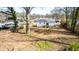 Expansive backyard featuring a cozy deck, offering an inviting outdoor retreat and lots of shade from mature trees at 122 Goldie Se Dr, Marietta, GA 30067