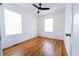 Bright bedroom featuring hardwood floors, a ceiling fan, and two windows at 122 Goldie Se Dr, Marietta, GA 30067