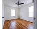 Bright bedroom featuring hardwood floors, a ceiling fan, and two windows at 122 Goldie Se Dr, Marietta, GA 30067