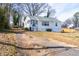 Cozy one-story home with a screened front porch and a cracked driveway leading up to the house at 122 Goldie Se Dr, Marietta, GA 30067