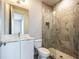 Cozy bathroom featuring a walk-in shower with modern tiles and fixtures, along with a single sink vanity at 131 City View Ne Ct, Atlanta, GA 30308