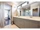 Bathroom featuring double vanity, modern lighting, large windows and doorway to the bedroom at 131 City View Ne Ct, Atlanta, GA 30308