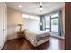 Bright bedroom featuring hardwood floors, a ceiling fan, and a large window at 131 City View Ne Ct, Atlanta, GA 30308