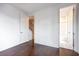 Bright bedroom featuring hardwood floors, neutral walls, and a doorway leading to an adjacent bathroom at 131 City View Ne Ct, Atlanta, GA 30308