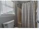 Bathroom featuring a tub/shower combination with a patterned shower curtain and window at 1953 Graystone Pkwy, Grayson, GA 30017