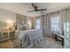 Cozy bedroom featuring a comfortable bed, ceiling fan, and a decorative rug at 1953 Graystone Pkwy, Grayson, GA 30017