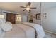 Spacious bedroom with a four-poster bed, ceiling fan, and a modern en-suite bathroom at 1953 Graystone Pkwy, Grayson, GA 30017