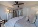 Comfortable bedroom with soft lighting, ceiling fan, and a view to other rooms at 1953 Graystone Pkwy, Grayson, GA 30017