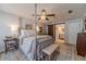 A view of the bedroom showcasing its four-poster bed, adjacent bathroom with sliding barn door at 1953 Graystone Pkwy, Grayson, GA 30017