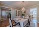 Formal dining room with hardwood floors, a chandelier, built-in display cabinet, and seating for four at 1953 Graystone Pkwy, Grayson, GA 30017