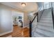 Foyer with hardwood floors, staircase with white risers, and entry to a living room at 1953 Graystone Pkwy, Grayson, GA 30017