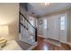 Foyer featuring a white front door with sidelights, hardwood floors, and a staircase at 1953 Graystone Pkwy, Grayson, GA 30017