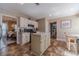 Well-lit kitchen with a center island, white cabinets, stainless steel appliances, and view to the dining room at 1953 Graystone Pkwy, Grayson, GA 30017