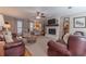 Spacious living room with a brick fireplace and neutral color palette at 1953 Graystone Pkwy, Grayson, GA 30017