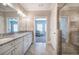 Ensuite bathroom featuring a double sink vanity, tile floors, and a glass enclosed shower at 203 Daisy Ne Ct, Cartersville, GA 30121