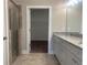 Spacious bathroom featuring dual sinks, granite countertops, and access to a walk-in closet at 203 Daisy Ne Ct, Cartersville, GA 30121