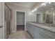 Bathroom featuring a double sink vanity with stone countertops and a glass enclosed shower at 203 Daisy Ne Ct, Cartersville, GA 30121