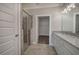 Bathroom featuring a glass enclosed shower and a double sink vanity with stone countertops at 203 Daisy Ne Ct, Cartersville, GA 30121