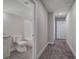 Hallway view of a bathroom featuring a toilet, vanity with granite countertop, and tub at 203 Daisy Ne Ct, Cartersville, GA 30121