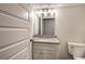 Bathroom featuring granite vanity, toilet and mirror at 203 Daisy Ne Ct, Cartersville, GA 30121