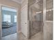 Ensuite bathroom featuring a glass enclosed shower and access to the bedroom at 203 Daisy Ne Ct, Cartersville, GA 30121