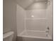 A bathroom with a clean, white bathtub and shower with chrome fixtures at 203 Daisy Ne Ct, Cartersville, GA 30121