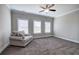 A spacious bedroom featuring three windows, neutral walls, and a loveseat at 203 Daisy Ne Ct, Cartersville, GA 30121