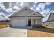 Charming single-Gathering home with a two-car garage, stone accents, and well-manicured lawn at 203 Daisy Ne Ct, Cartersville, GA 30121