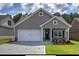 Single-Gathering home with a two-car garage, stone accents, and a manicured front lawn at 203 Daisy Ne Ct, Cartersville, GA 30121