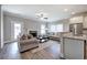 Open-concept living room featuring a fireplace, hardwood floors, and a kitchen island at 203 Daisy Ne Ct, Cartersville, GA 30121