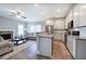 Bright and airy living room with a fireplace, hardwood floors, and a kitchen island at 203 Daisy Ne Ct, Cartersville, GA 30121