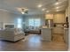 Living room open to the kitchen with stainless steel appliances and an island with granite countertops at 203 Daisy Ne Ct, Cartersville, GA 30121