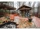 Amazing backyard with tiki bar, pergola, firepit, stone patio, and wooden deck, perfect for entertaining at 402 Rising Cir, Woodstock, GA 30189