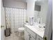 A clean bathroom featuring modern fixtures, neutral color scheme, and a shower with decorative curtain at 402 Rising Cir, Woodstock, GA 30189