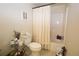 Small bathroom showing a toilet with ruffled cover and tub/shower with white curtain at 402 Rising Cir, Woodstock, GA 30189