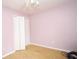 An empty bedroom ready for new occupants is painted pink with carpeted floor at 402 Rising Cir, Woodstock, GA 30189